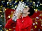 Novak Djokovic of Serbia poses for photographers with the winner's trophy after defeating Juan Martin Del Potro of Argentina in the Shanghai Masters final on October 13, 2013