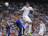 Raphael Varane of Real Madrid CF heads the ball beside Ragnar Sigurdsson of FC Copenhagen during the UEFA Champions League match between Real Madrid CF and FC Copenhagen at Estadio Santiago Bernabeu on October 2, 2013