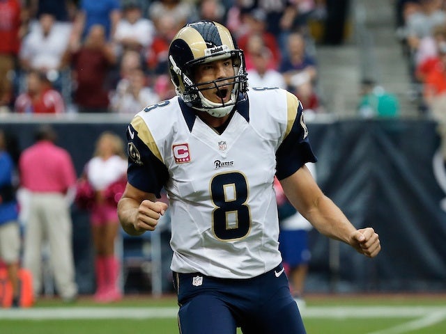 Sam Bradford of the St. Louis Rams celebrates a second quarter touchdown pass against the Houston Texans at Reliant Stadium on October 13, 2013 