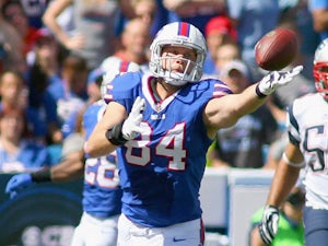 Scott Chandler #84 of the Buffalo Bills reaches to make a catch against the New England Patriots at Ralph Wilson Stadium on September 8, 2013