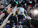 Sebastian Vettel of Germany and Red Bull Racing celebrates with teammates after finishing third to secure his second F1 World Drivers Championship during the Japanese Grand Prix on October 9, 2011 