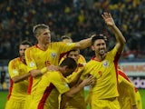 Ciprian Marica of Romania celebrates scoring the second goal with his teammates during the FIFA 2014 World Cup group D qualifying football match against Estonia on October 15 2013