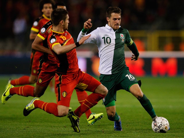 Sebastien Pocognoli of Belgium is beaten by Aaron Ramsey of Wales during the FIFA 2014 World Cup Qualifying Group A match between Belgium and Wales at King Baudouin Stadium on October 15, 2013