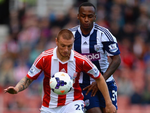 Andy Wilkinson of Stoke City and Saido Berahino of West Brom battle for the ball during the Barclays Premier League match between Stoke City and West Brom on October 19, 2013