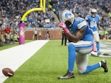 Tight end Brandon Pettigrew #87 of the Detroit Lions celebrates after he ran in a touchdown during the first half against the Cincinnati Bengals at Ford Field on October 20, 2013
