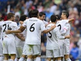 Real Madrid's Portuguese forward Cristiano Ronaldo celebrates with teammates after scoring during the Spanish league football match Real Madrid vs Malaga on October 19, 2013