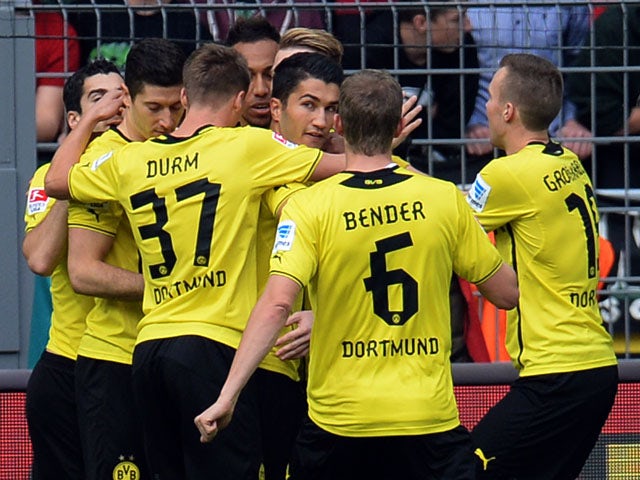 Dortmund's midfielder Nuri Sahin and his teammates celebrate during the German first division Bundesliga football match Borussia Dortmund vs Hannover 96 in the German city of Dortmund on October 19, 2013