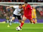 James Milner of England and Fatos Beqiraj of Montenegro compete for the ball during the FIFA 2014 World Cup Qualifying Group H match between England and Montenegro at Wembley Stadium on October 11, 2013 