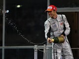 Jenson Button of Great Britain and Brawn GP celebrates on the podium after finishing third during the Abu Dhabi Formula One Grand Prix at the Yas Marina Circuit on November 1, 2009