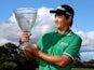 Jin Jeong of Korea holds aloft the winners trophy after defeating Ross Fisher of England on a play-off hole to win the tournament during day four of the Perth International at Lake Karrinyup Country Club on October 20, 2013