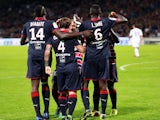 Bordeaux' Polish midfielder Ludovic Obraniak is congratulated by teammates after scoring a goal against Lyon on October 20, 2013 
