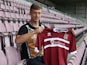 Northampton Town new signing Luke Norris poses with a shirt during a photo call at Sixfields Stadium on October 18, 2013