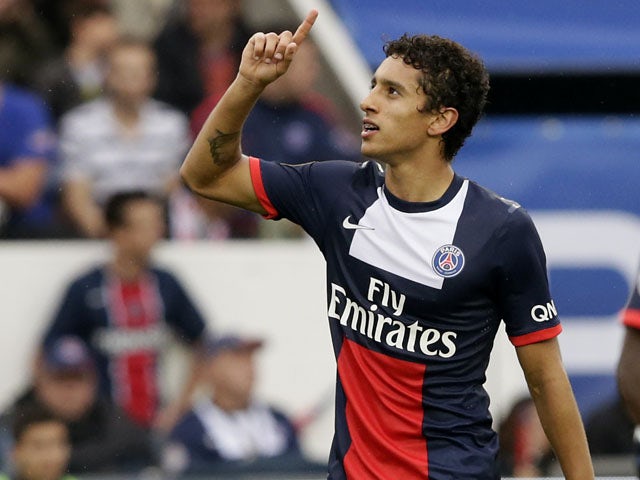 Paris Saint-Germain's Brazilian defender Marquinhos celebrates after scoring a goal during the French L1 football match between Paris Saint-Germain and Toulouse at the Parc des Princes Stadium in Paris on September 28, 2013