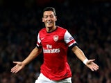 Arsenal midfielder Mesut Ozil celebrates scoring the opening goal against Napoli in the Champions League at the Emirates on October 1, 2013