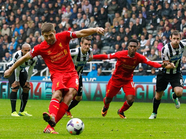 Steven Gerrard of Liverpool scores his 100th goal and Liverpool's first from the penalty spot during the Barclays Premier League match between Newcastle United and Liverpool at St James' Park on October 19, 2013