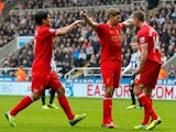 Steven Gerrard of Liverpool celebrates after scoring his 100th Premier League goal and his team's first with team-mates Jordan Henderson and Luis Suarez during the Barclays Premier League match between Newcastle United and Liverpool at St James' Park on O