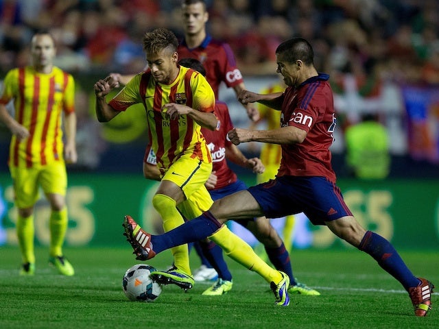 Barca striker Neymar competes for the ball with Francisco Andres Silva of CA Osasuna during the La Liga match on October 19, 2013