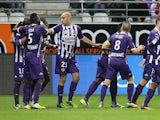 Toulouse's teammates celebrate after Oscar Trejo scored a goal during the French L1 football match Reims vs Toulouse on October 18, 2013