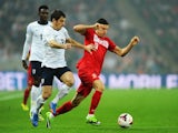 Robert Lewandowski of Poland is challenged by Leighton Baines of England during the FIFA 2014 World Cup Qualifying Group H match on October 15, 2013