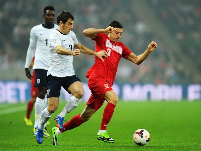 Robert Lewandowski of Poland is challenged by Leighton Baines of England during the FIFA 2014 World Cup Qualifying Group H match on October 15, 2013