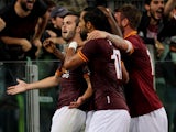 Miralem Pjanic with his team-mates of AS Roma celebrates after scoring the opening goal during the Serie A match between AS Roma and SSC Napoli at Stadio Olimpico on October 18, 2013