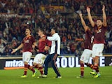 AS Roma's players celebrate at the end of the Serie A football match AS Roma vs Napoli on October 18, 2013
