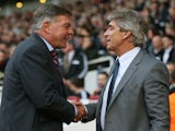 Sam Allardyce the West Ham manager and Manuel Pellegrini the Manchester City manager greet each other prior to kickoff during their Barclays Premier League match on October 19, 2013