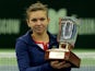Romania's Simona Halep holds her trophy after her victory over Australia's Samantha Stosur in the Kremlin Cup tennis tournament final match in Moscow on October 20, 2013
