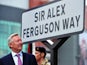 Former Manchester United manager Sir Alex Ferguson unveils a sign after a road near to Old Trafford Stadium was renamed in his honour in Manchester on October 14, 2013