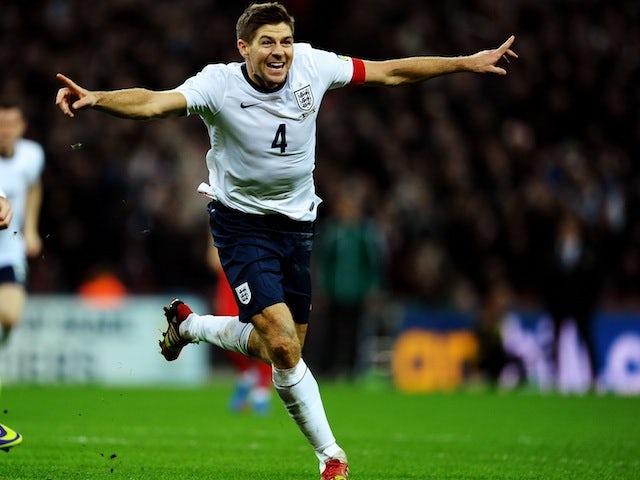 Steven Gerrard wheels away in celebration after scoring the second goal at Wembley against Poland to secure England's place in the 2014 World Cup on October 15, 2013