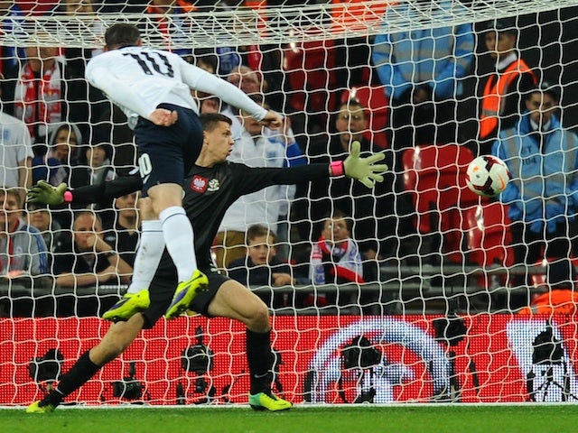 Wayne Rooney of England scores his team's opening goal during the FIFA 2014 World Cup Qualifying Group H match between England and Poland at Wembley Stadium on October 15, 2013