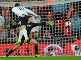 Wayne Rooney of England scores his team's opening goal during the FIFA 2014 World Cup Qualifying Group H match between England and Poland at Wembley Stadium on October 15, 2013