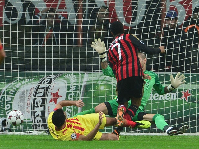 AC Milan's Brazilian forward Robinho kicks and scores during the Champion's League football match AC Milan vs FC Barcelona, on October 22, 2013