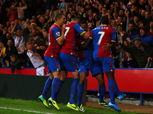 Crystal Palace's Adrian Mariappa is congratulated by team mates after scoring the opening goal against Fulham on October 21, 2013