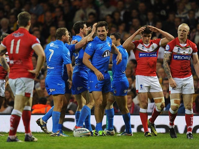 Italy's Aidan Guerra celebrates with his team after scoring the opening try against Wales during their World Cup match on October 26, 2013