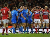 Italy's Aidan Guerra celebrates with his team after scoring the opening try against Wales during their World Cup match on October 26, 2013