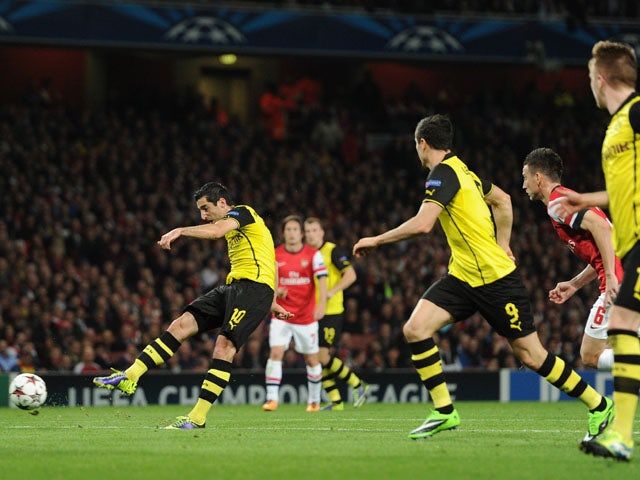 Henrik Mkhitaryan of Borussia Dortmund scores the first goal during the UEFA Champions League Group F match between Arsenal and Borussia Dortmund at Emirates Stadium on October 22, 2013