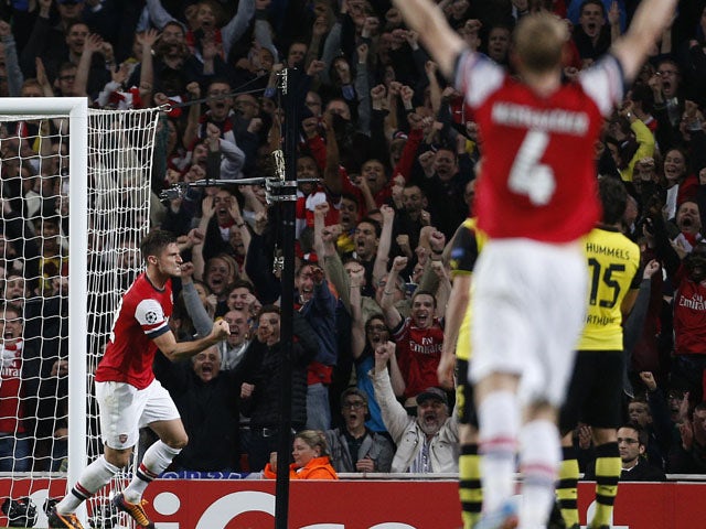 Arsenal's French striker Olivier Giroud celebrates scoring their first goal during the UEFA Champions League Group F football match between Arsenal and Borussia Dortmund at the Emirates Stadium, north London, on October 22, 2013