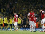 Arsenal's French striker Olivier Giroud and German midfielder Mesut Ozil react after Borussia Dortmund score their second goal during the UEFA Champions League Group F football match between Arsenal and Borussia Dortmund at the Emirates Stadium, north Lon