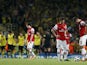 Arsenal's French striker Olivier Giroud and German midfielder Mesut Ozil react after Borussia Dortmund score their second goal during the UEFA Champions League Group F football match between Arsenal and Borussia Dortmund at the Emirates Stadium, north Lon