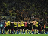 Borussia Dortmund players celebrate victory at the final whistle with his team mates during the UEFA Champions League Group F match between Arsenal and Borussia Dortmund at Emirates Stadium on October 22, 2013
