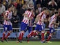 Atletico Madrid's Forward Oliver celebrates with teammates after scoring during the Spanish league football match Club Atletico de Madrid vs Betis at the Vicente Calderon stadium in Madrid on October 27, 2013