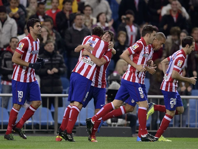 Atletico Madrid's Forward Oliver celebrates with teammates after scoring during the Spanish league football match Club Atletico de Madrid vs Betis at the Vicente Calderon stadium in Madrid on October 27, 2013