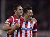 Atletico Madrid's forward David Villa celebrates after scoring during the Spanish league football match Club Atletico de Madrid vs Betis at the Vicente Calderon stadium in Madrid on October 27, 2013