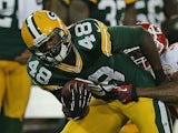 Brandon Bostick of the Green Bay Packers hold off Kansas City's Mikail Baker during a preseason game at Lambeau Field on August 30, 2012