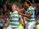 James Forrest of Celtic is congratulated by teammate Virgil van Dijk of Celtic after scoring the opening goal from the penalty spot during the UEFA Champions League Group H match between Celtic and Ajax at Celtic Park Stadium on October 22, 2013