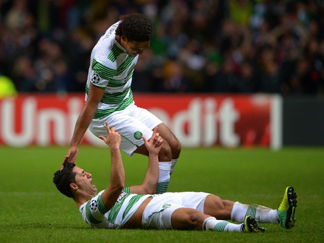 Biram Kayal of Celtic is congratulated by teammate Virgil van Dijk of Celtic after scoring his team's second goal during the UEFA Champions League Group H match between Celtic and Ajax at Celtic Park Stadium on October 22, 2013