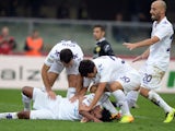Juan Guillermo Cuadrado of ACF Fiorentina (C) is congratulated by team-mates after scoring their team's first goal to equalise during the Serie A match between AC Chievo Verona and ACF Fiorentina at Stadio Marc'Antonio Bentegodi on October 27, 2013