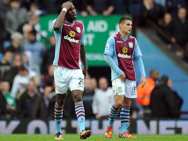 Christian Benteke of Aston Villa looks dejected following Everton's second goal during the Barclays Premier League match on October 26, 2013