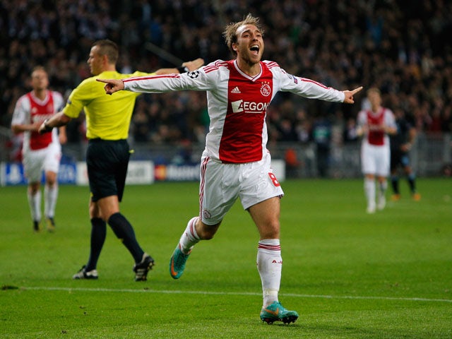 Christian Eriksen (#8) of Ajax celebrates after he shoots and scores his teams third goal of the game during the Group D UEFA Champions League match between AFC Ajax and Manchester City FC at Amsterdam ArenA on October 24, 2012